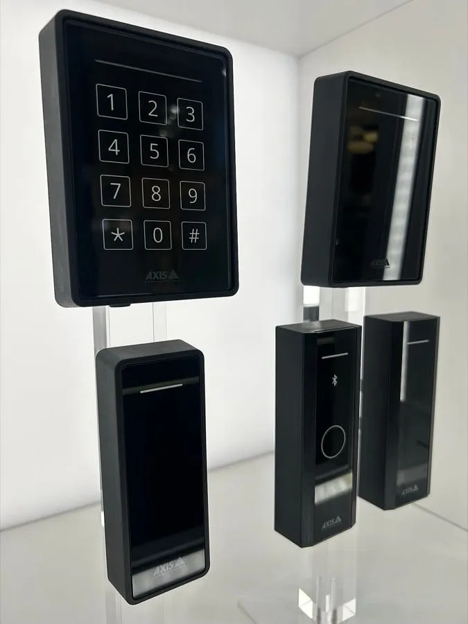 Five black card readers displayed on a white surface. One has a numeric keypad, the others are plain panels of varying width, and each carries a small indicator strip.