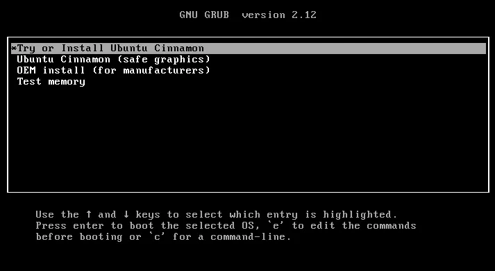 A GRUB boot menu on a black screen. The header reads GNU GRUB version 2.12. Four entries are listed in a bordered box, the first highlighted: Try or Install Ubuntu Cinnamon, Ubuntu Cinnamon in safe graphics mode, OEM install for manufacturers, and Test memory. Below the box, three lines of help text explain that the up and down arrow keys move the highlight, enter boots the selected entry, the e key edits the commands before booting, and the c key opens a command line.