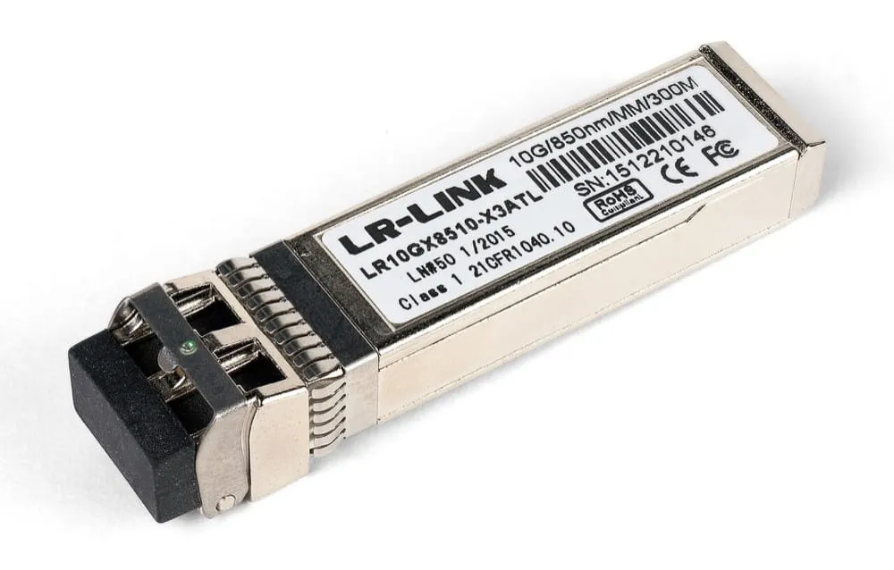 A metal SFP+ transceiver module photographed at an angle against a white background. The printed label on the side reads LR-LINK, part number LR10GX8510-X3ATL, and along the top edge of the label, 10G/850nm/MM/300M. The front of the module has a black dust plug covering a duplex LC receptacle; the rear has a ridged latch and the edge connector that seats into the switch cage.
